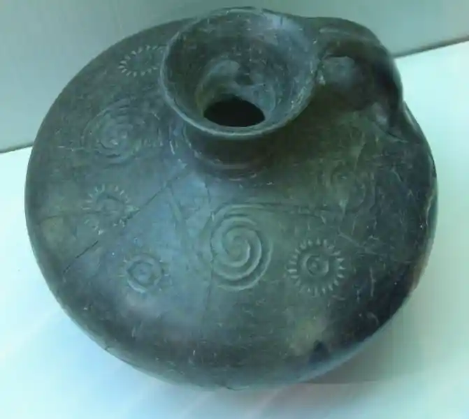 A vase with a narrow mouth and a small handle